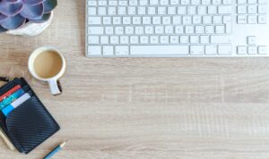 white apple keyboard near white cup